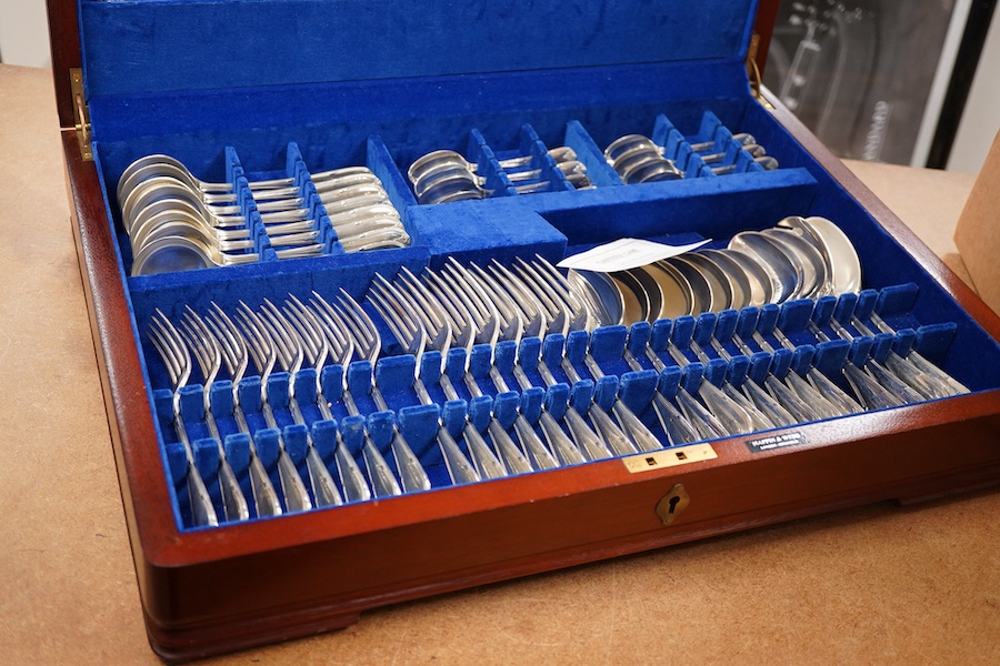 An Elizabeth II canteen of silver cutlery for eight, by Mappin & Webb, comprising table and dessert forks, dessert, soup and teaspoons, silver handled steel table and dessert knives two table or serving spoons and a pair